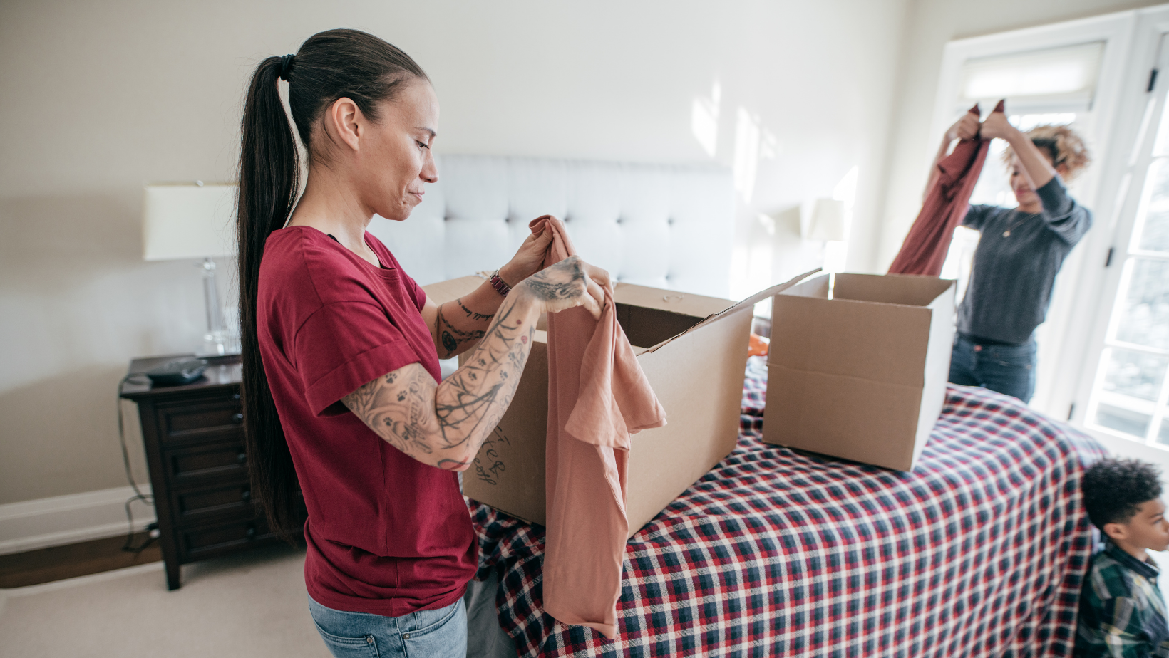 woman unpacking moving box