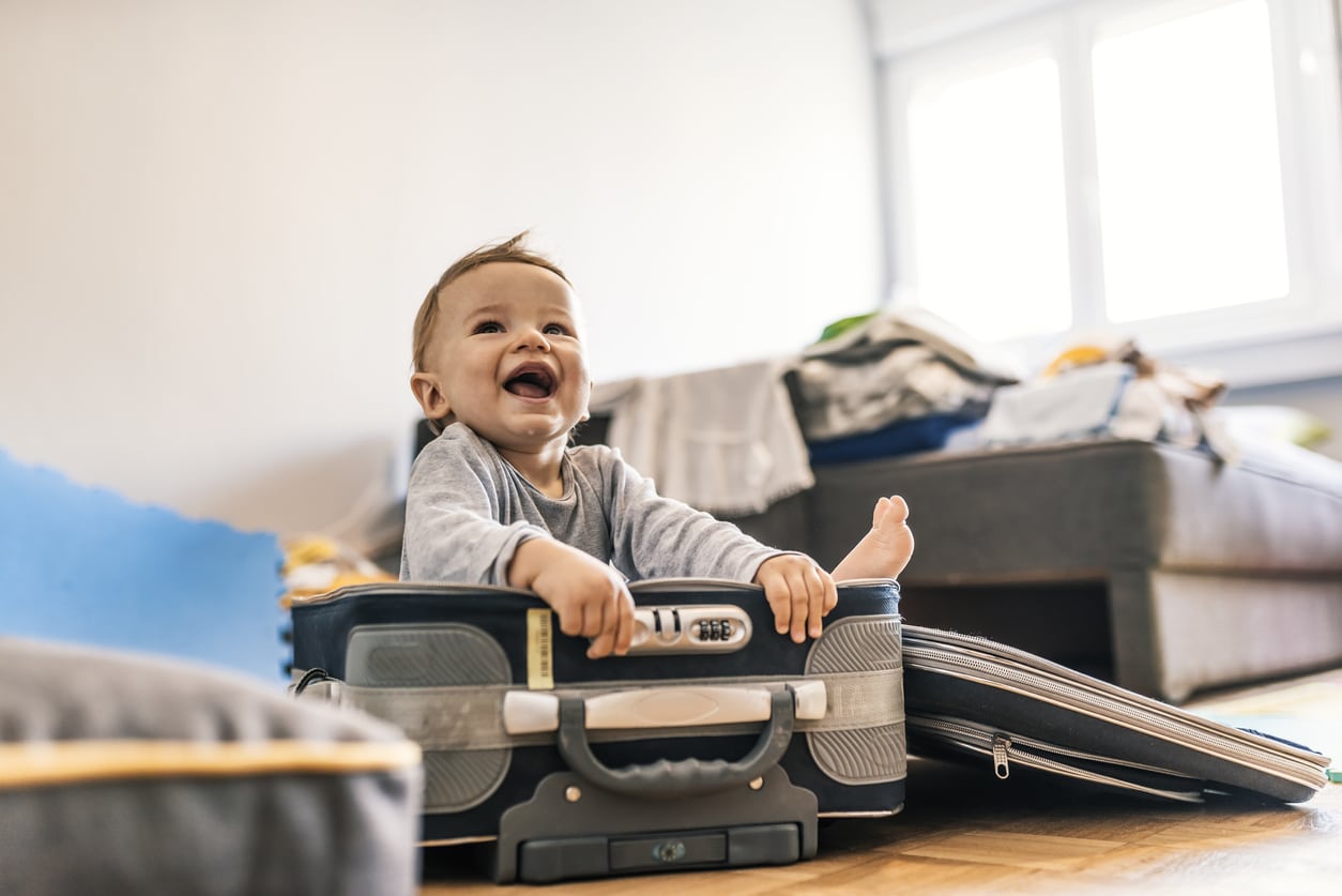 happy toddler in suitcase