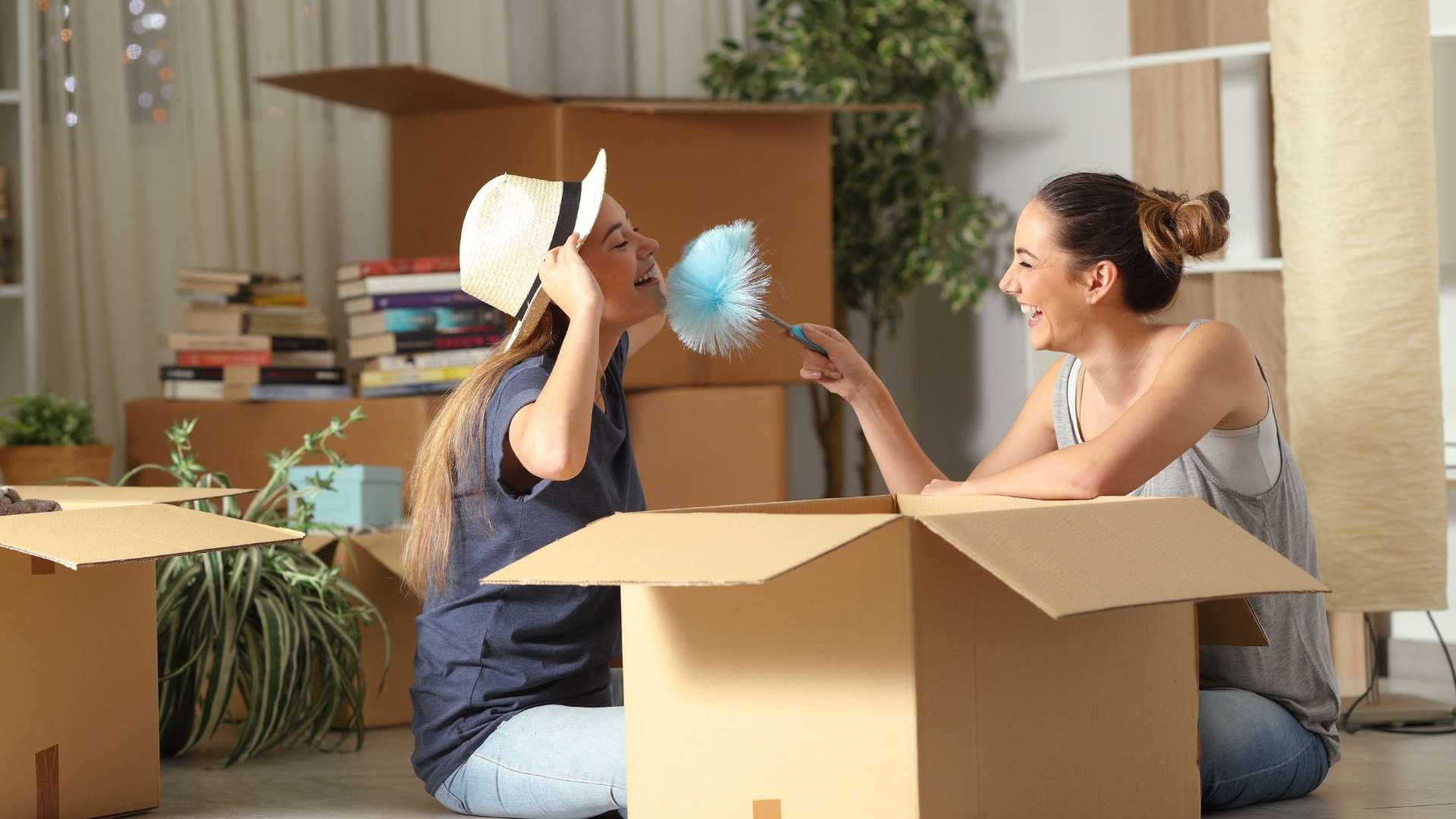 roommates playing with feather duster while moving