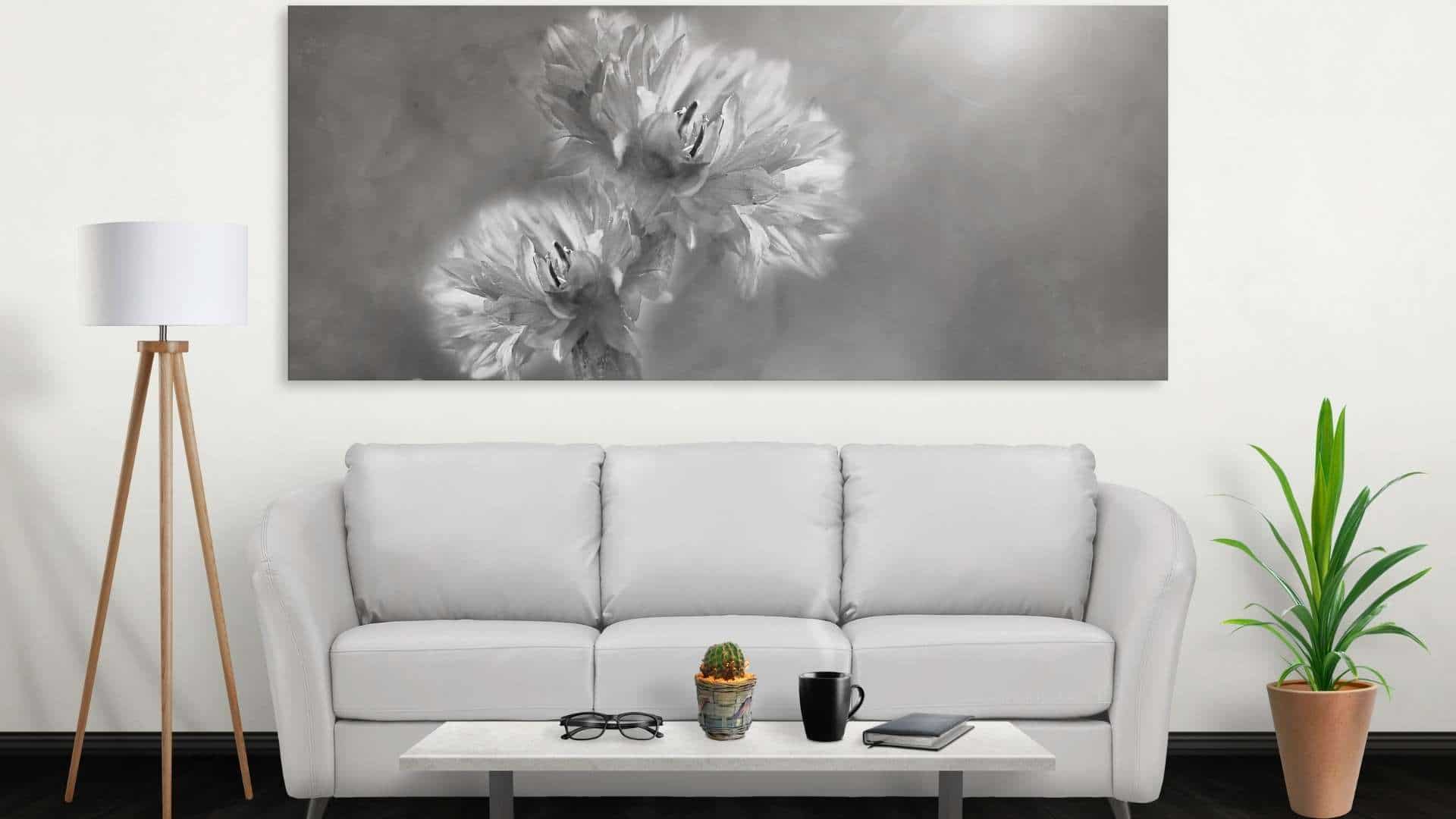 black and white flower portrait above white couch